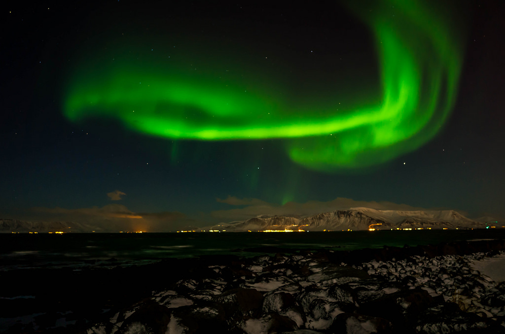green swirling Northern Lights over Reykjavik