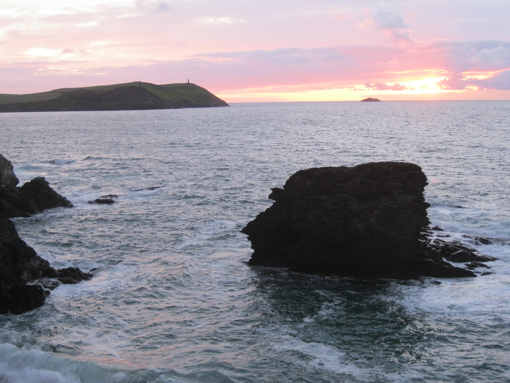 Pink and golden sunset over the sea at Polzeath