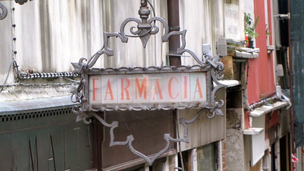 Venice with teens: metal pharmacy sign. Copyright©2015 reserved to photographer. Contact mapandfamily.com