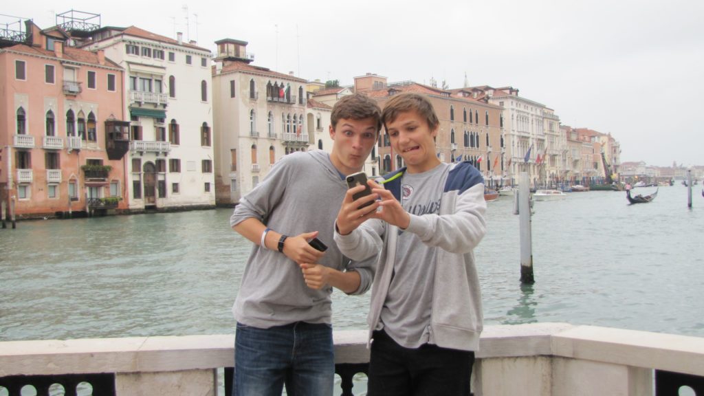Venice with teens: viewing selfies on terrace. Copyright©2015 reserved to photographer. Contact mapandfamily.com