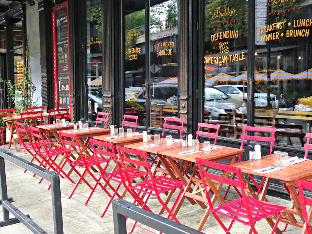 New York with teens: red chairs outside Bubbys. Copyright©2015 reserved Nancy Roberts. Contact mapandfamily.com