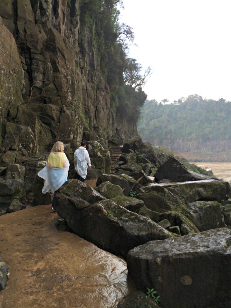 Family holiday Iguacu falls visitors walking beside rocks. Copyright©2016 reserved to photographer via mapandfamily.com