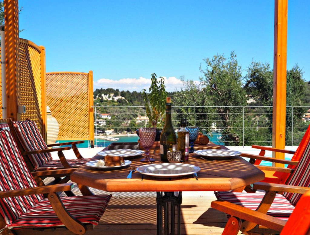 Lunch table set under pergola on terrace at villa in Lakka Paxos. Copyright © 2017 mapandfamily.com 