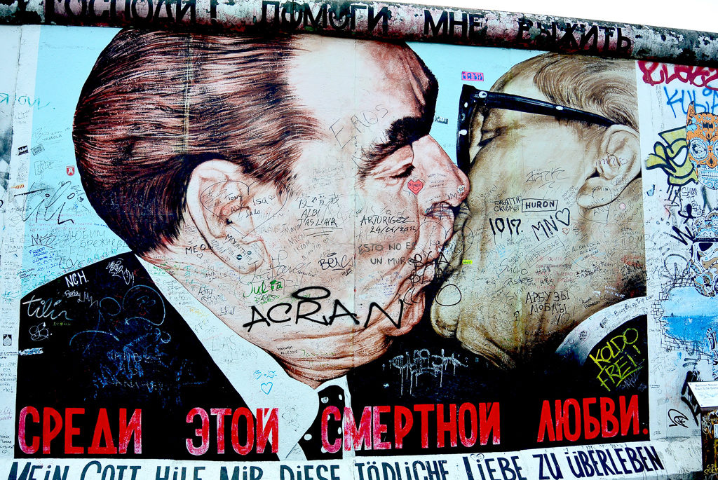 Image of two politicians from East Side Gallery Berlin. Top interrailing tips for train travel in Europe