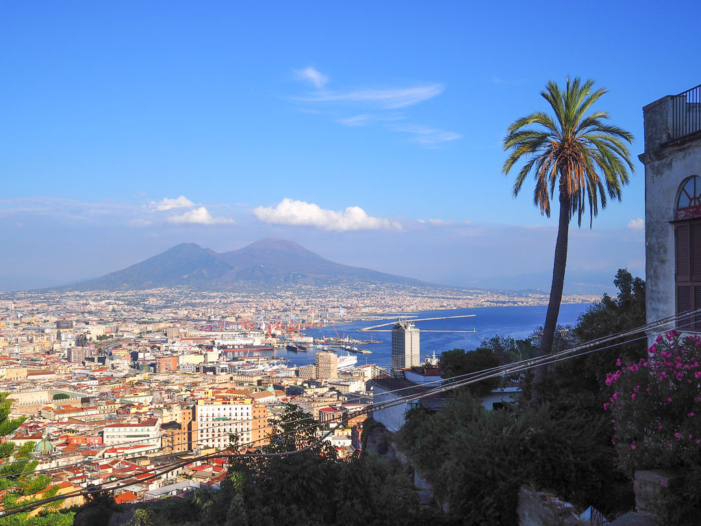 One of the top things to do in Naples Italy is this rooftop view of Naples from Vomero showing city and Vesuvius in the distance. Copyright@2019 mapandfamily.com 