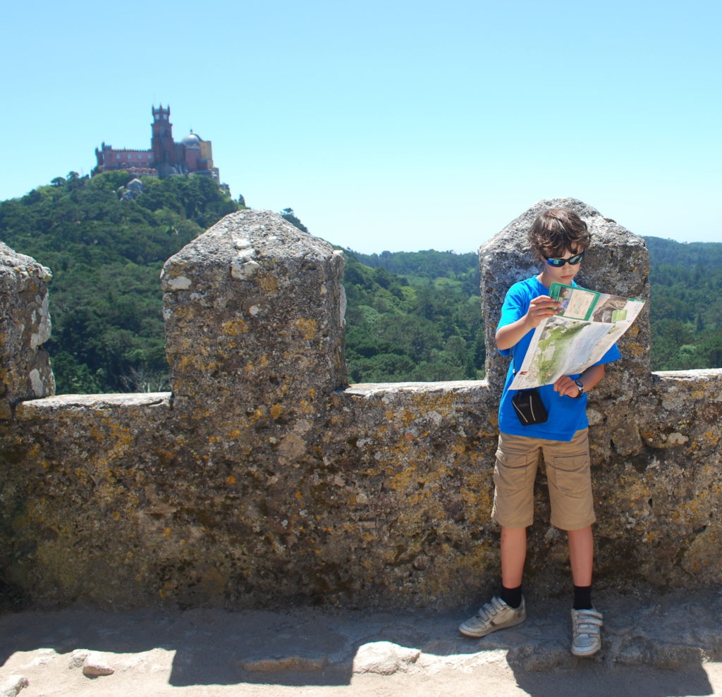 Lisbon for kids. Boy with map at Moorish castle, Sintra. Copyright©2015 reserved to photographer. Contact mapandfamily.com