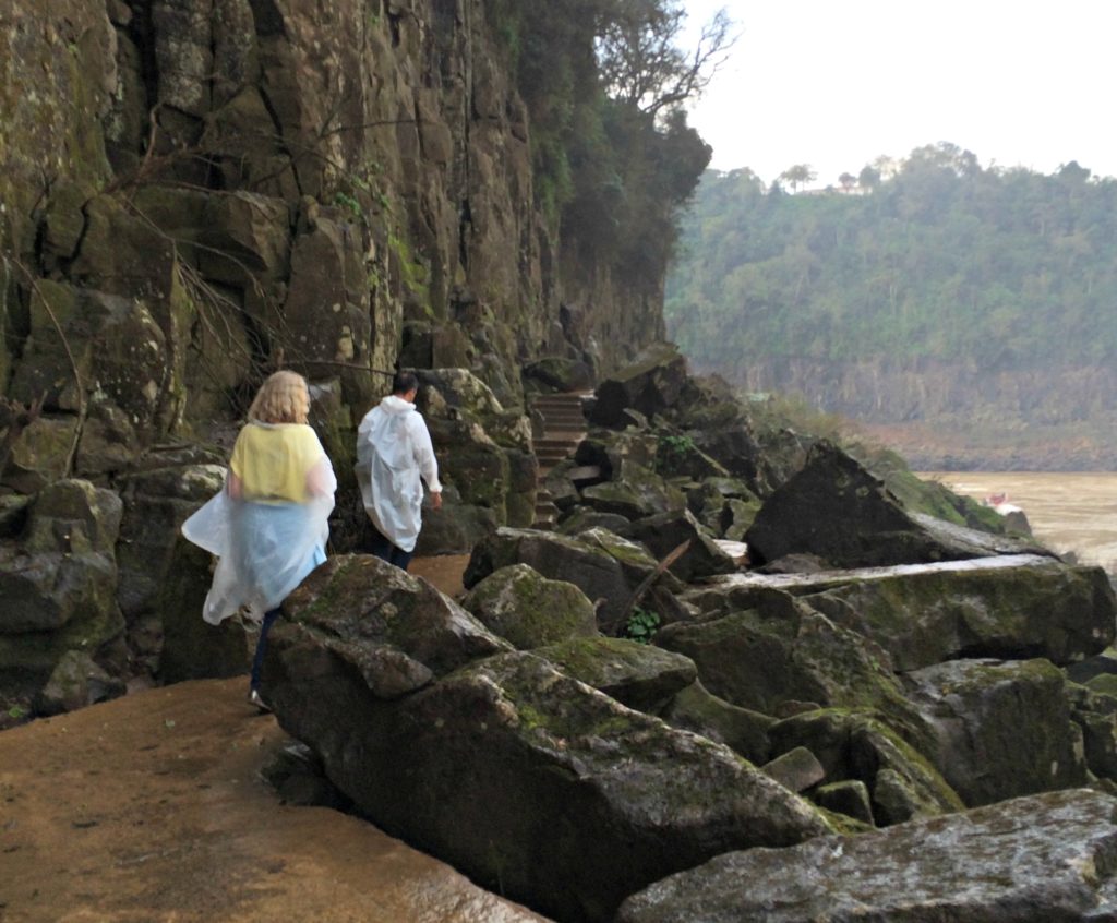 Family holiday Iguacu falls visitors walking beside rocks. Copyright©2016 reserved to photographer via mapandfamily.com