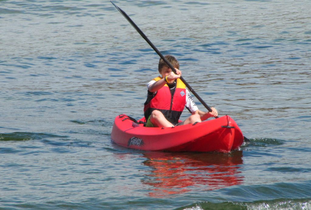 plan a holiday with teenagers: boy in red kayak Copyright©2017 reserved to photographer via mapandfamily.com 