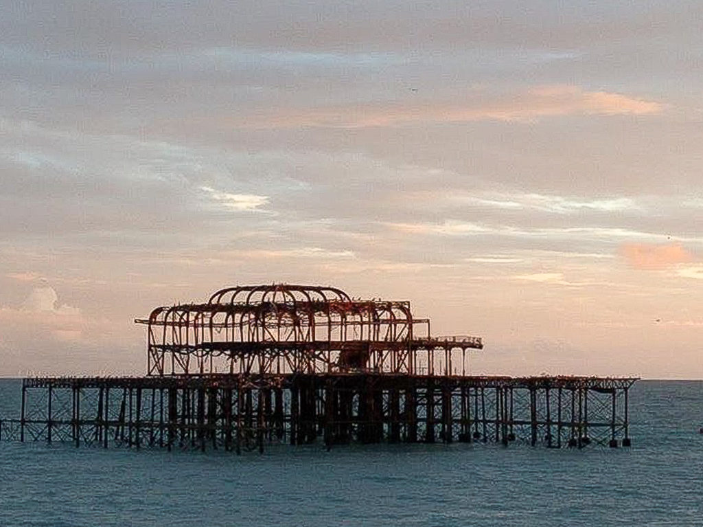 Brighton pier: the skeleton of West Pier Brighton photographed at sunset copyright @2018 reserved to photographer via mapandfamily.com