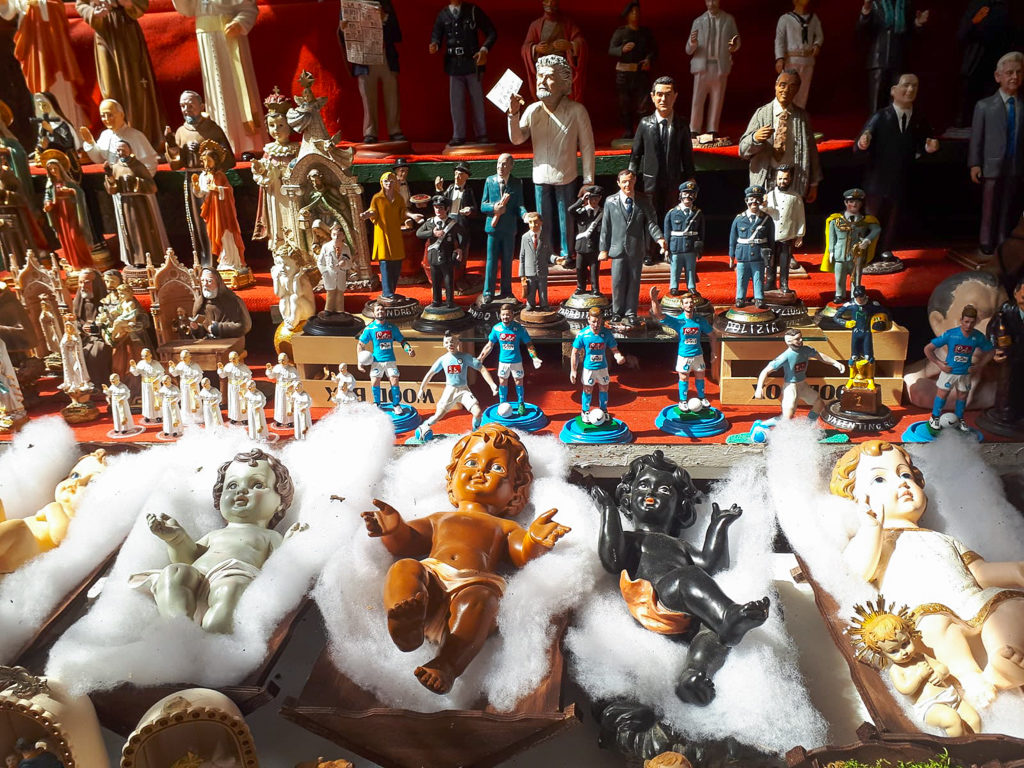 Pop culture figures and traditional nativity cribs on a stall in Via Gregorio Armeno Naples 