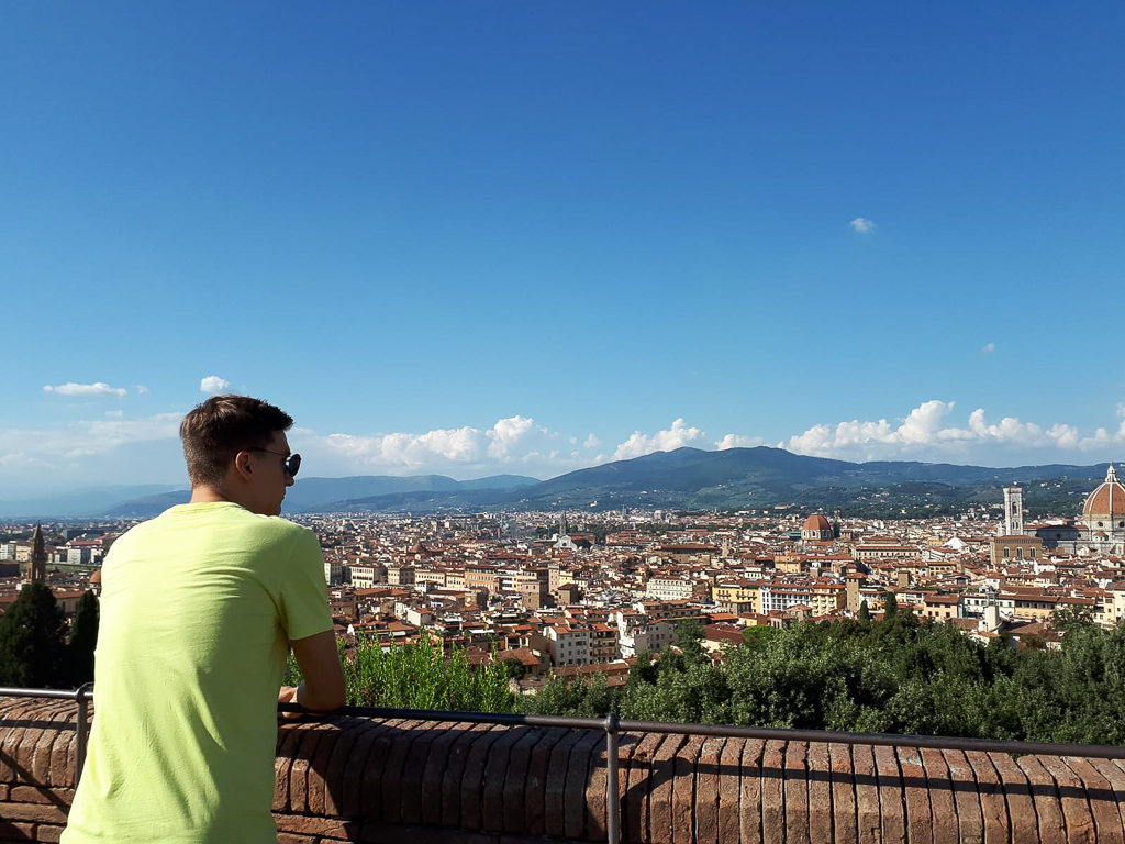 Boy leaning on railings overlooking city of Florence. Copyright©2018 mapandfamily.com 