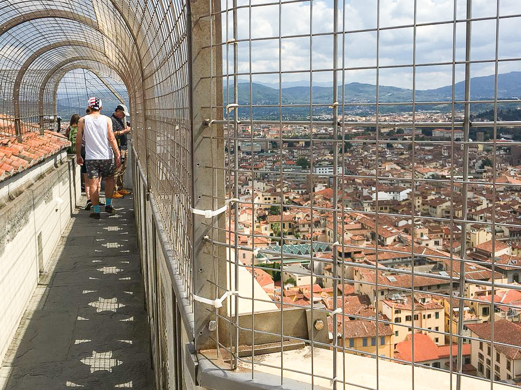 Visiting the Duomo in Florence. View of the walkway on top of Giotto's tower with protective wire fencing. Copyright©2018 mapandfamily.com 