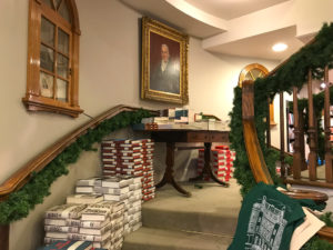 Interior of Hatchard's bookshop, Piccadilly with books piled on staircase. Copyright ©2018 mapandfamily.com 