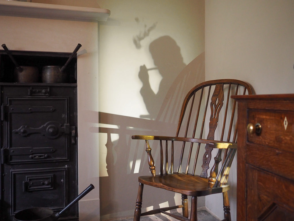 Shadow of man smoking pipe projected onto kitchen wall in Turner's House. Copyright ©2018 mapandfamily.com 