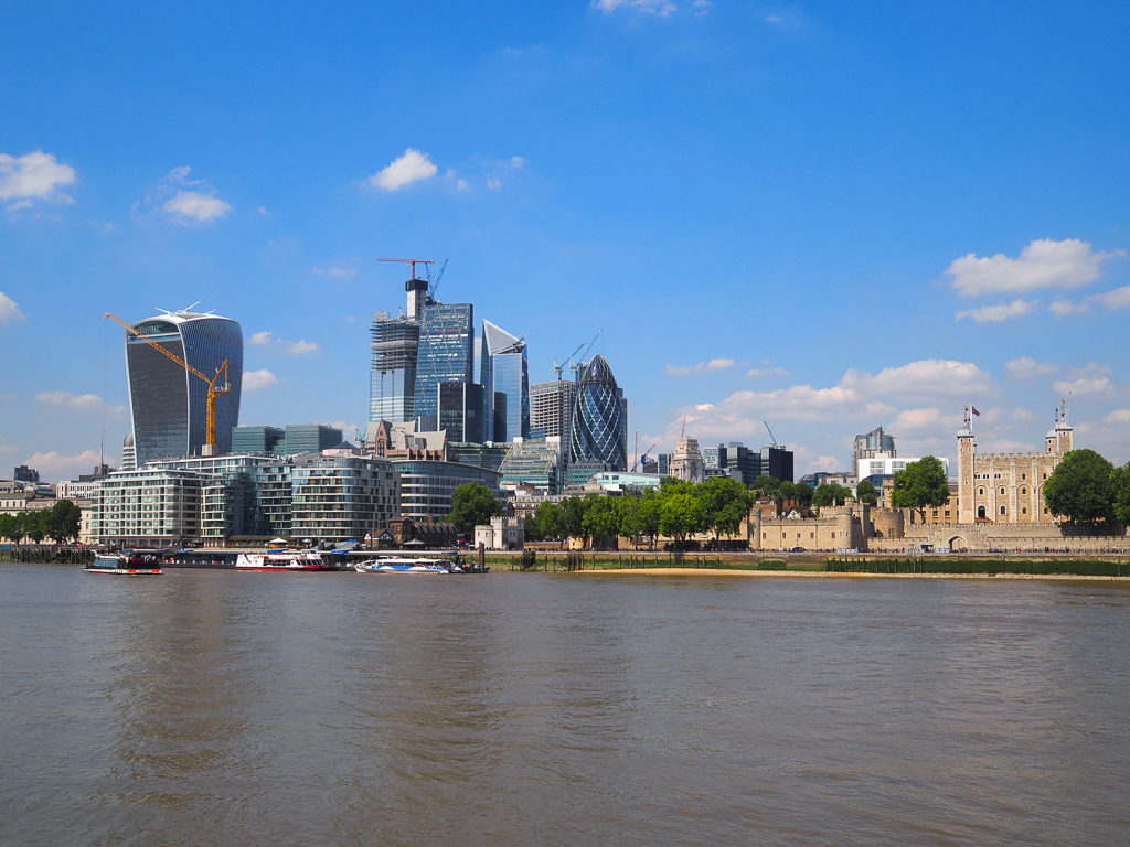 View across Thames river to skyscrapers and Tower of London showing contrast in size. Copyright ©2019 mapandfamily.com 