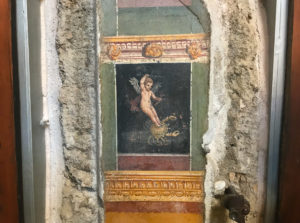 Wall painting of cupid riding a crab in Pompeii house. Copyright©2019 mapandfamily.com