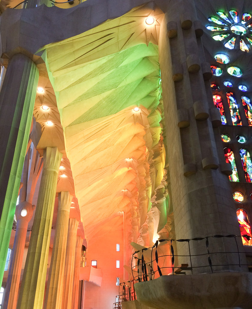 Washes of green and orange light inside Sagrada Familia. Copyright© 2019 mapandfamily.com 
