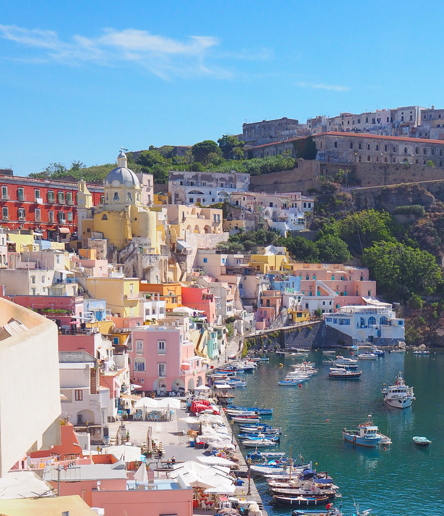 Procida Italy view of pastel coloured houses overlooking Corricella harbour. Copyright©2019 mapandfamily.com 