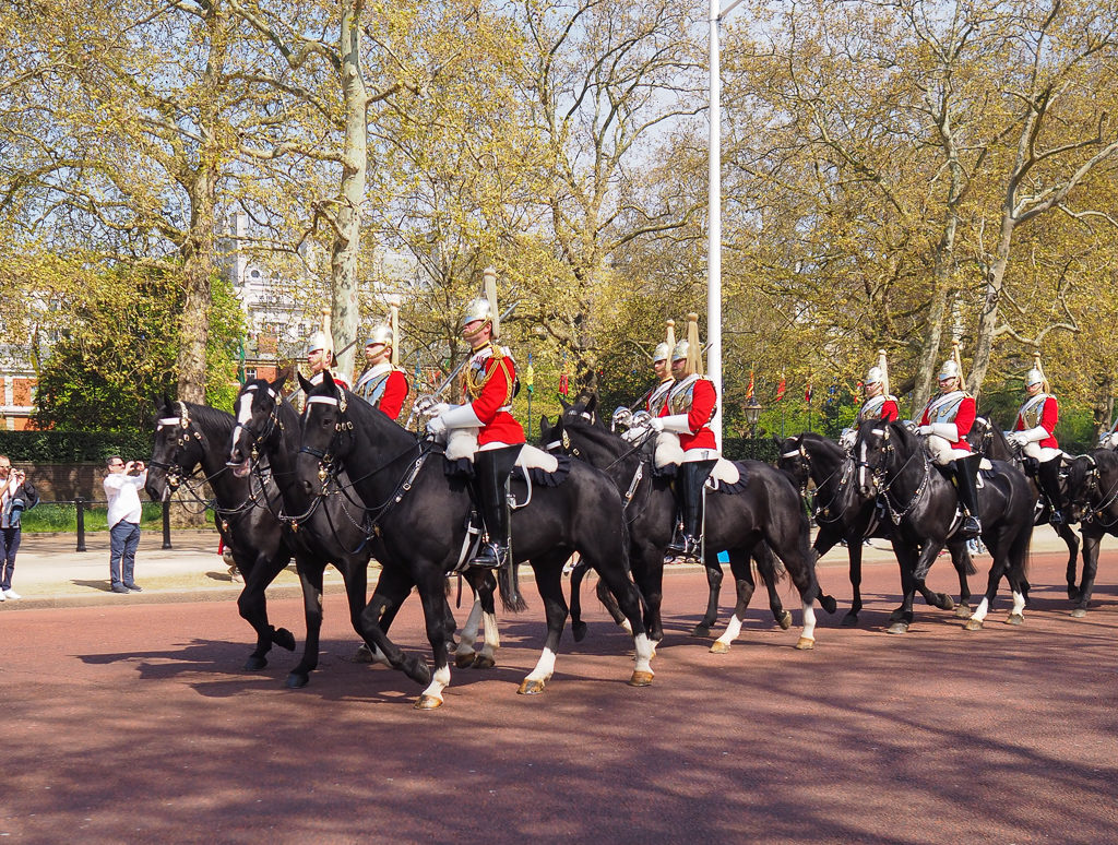 2 Days in London. Soldiers in red jackets with tall helmets, riding black horses down The Mall.  Copyright ©2019 mapandfamily.com 