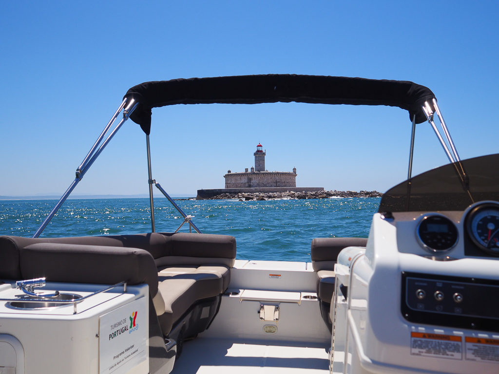 View of sea on a boat trip from Cascais with fortified lighthouse in Tagus estuary. Copyright ©2019 mapandfamily.com 