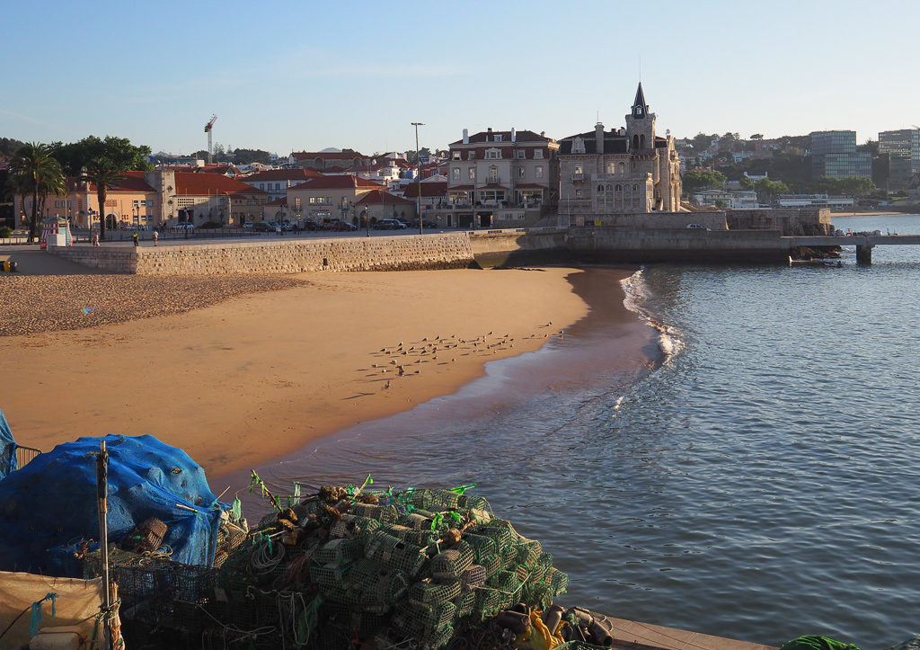 Cascais beach with fishing nets on the harbour side in early morning. Copyright ©2019 mapandfamily.com 