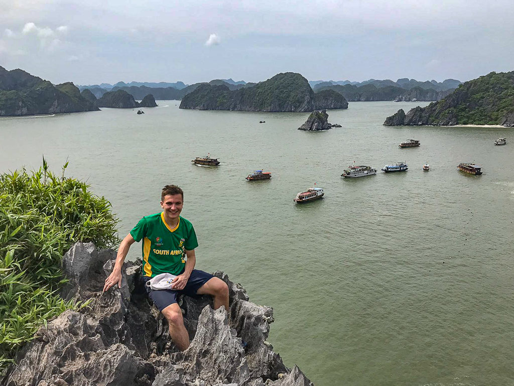 3 weeks in Vietnam. Boy on promontory overlooking boats and islands in bay. Copyright ©2019 mapandfamily.com