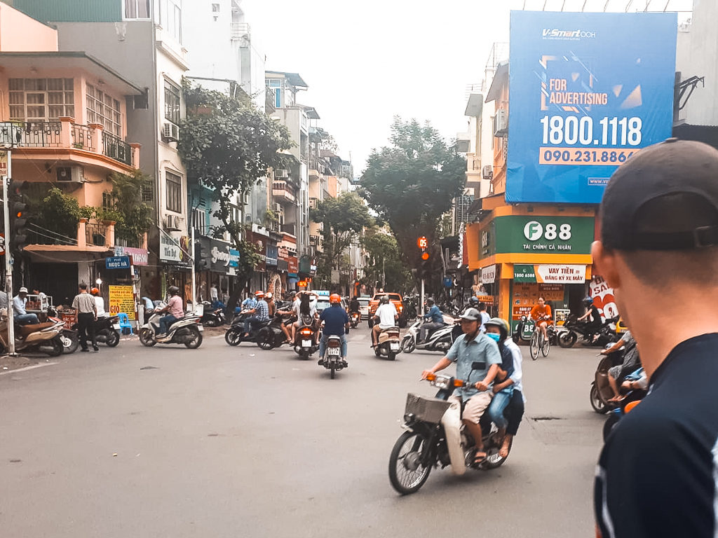 3 weeks in Vietnam. A busy street in Hanoi with scooters travelling in different directions. Copyright ©2019 mapandfamily.com. 
