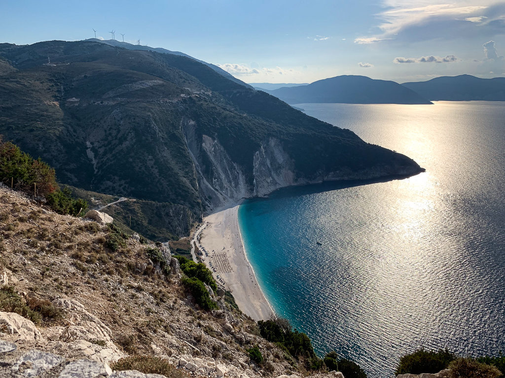 Kefalonia beaches. Late afternoon sunshine on Myrtos bay seen from above. Copyright ©2019 mapandfamily.com 