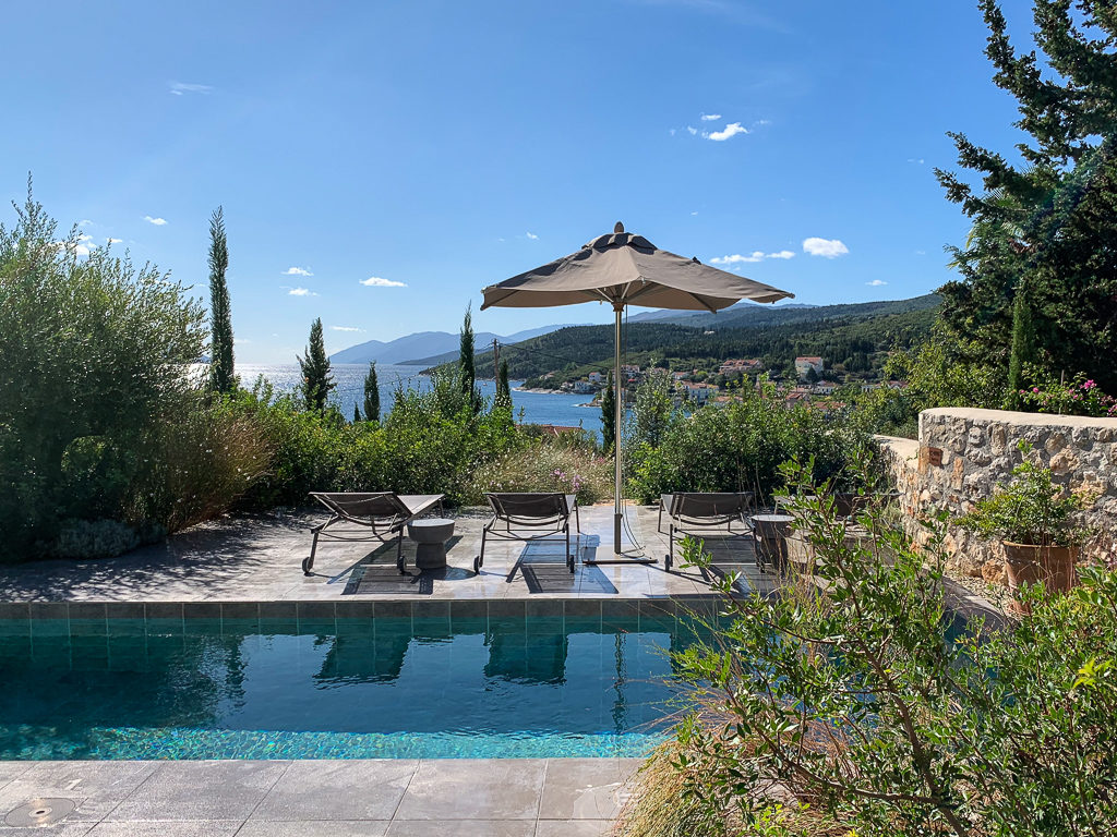 Best place to stay in Kefalonia? Terrace of villa with plunge pool and umbrella and views over Fiscardo bay.Copyright ©2020 mapandfamily.com 