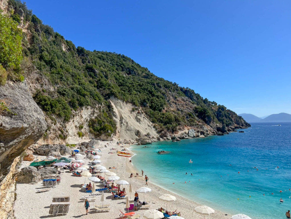 A pretty beach and wooded cliffside on Lefkada island. Copyright@2025 NancyRoberts