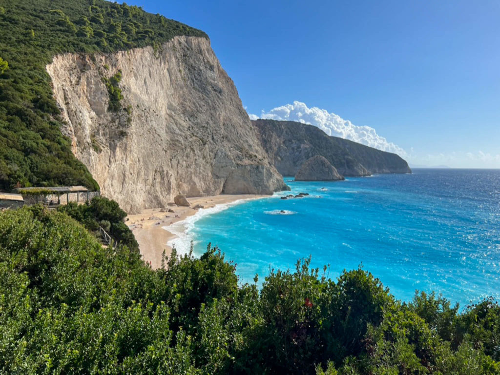 Porto Katsiki beach in Lefkada, Greece. Sheer white cliffs and bright turquoise water. Copyright@ 2022 mapandfamily.com 