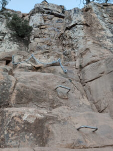 Staples and chains attached to the rocks on a steep rocky route up Lion's Head. Copyright@2023 reserved to photographer via mapandfamily.com