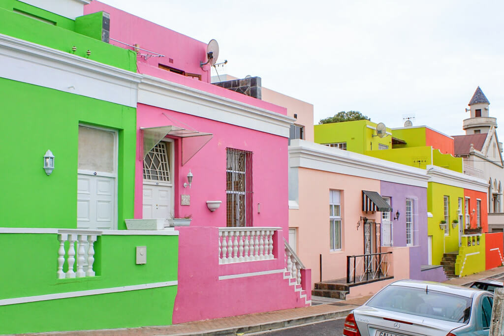 Multi-coloured houses with white trim on a road in Bo Kaap, Cape Town. Copyright@2023 reserved to photographer via mapandfamily.com