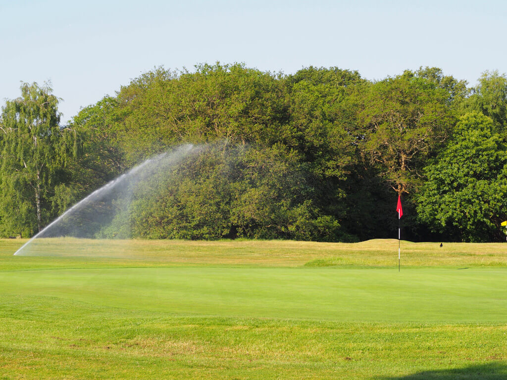 A spray of water falling on the green of golf course in Wimbledon. Copyright@2023mapandfamily.com 