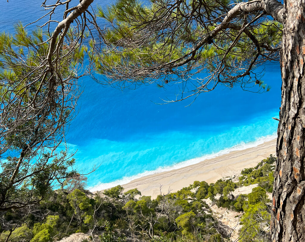 View of the turquoise sea and pale sand on south west coast beaches on Lefkada. Copyright@2023mapandfamily.com 