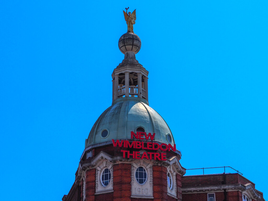 The dome of the New Wimbledon Theatre against a blue sky. Copyright@2023mapandfamily.com 
