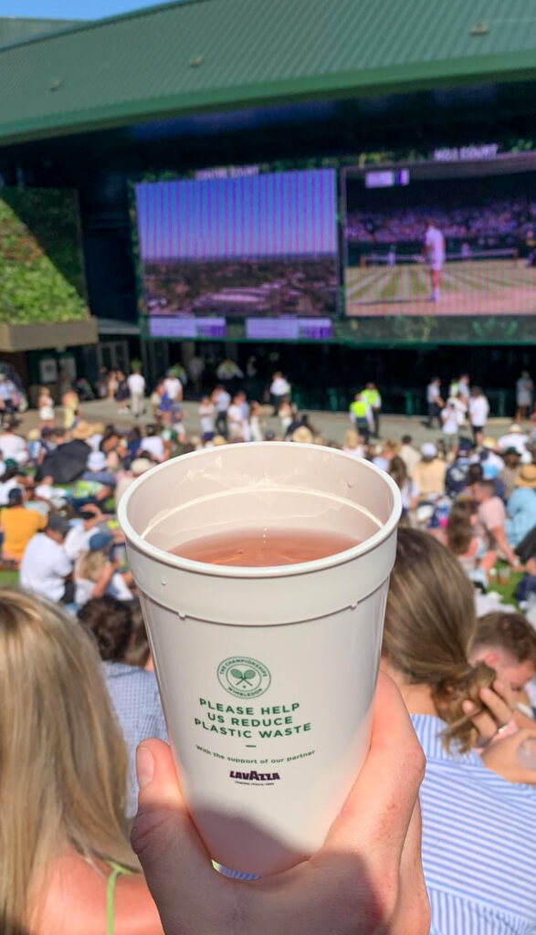 Wimbledon reuseable cup in front of screen on Hill. Copyright@2023mapandfamily.com 