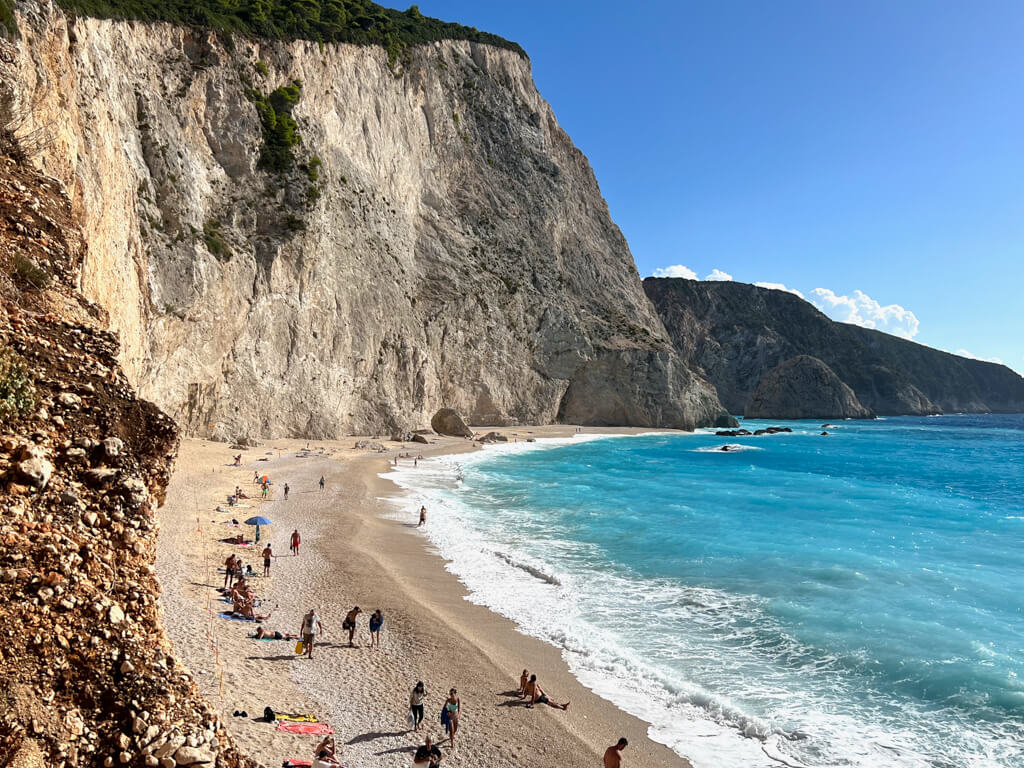 Sheer cliffs and pale sand border turquoise sea at Porto Katsiki beach on Lefkada. Copyright@2023mapandfamily.com 