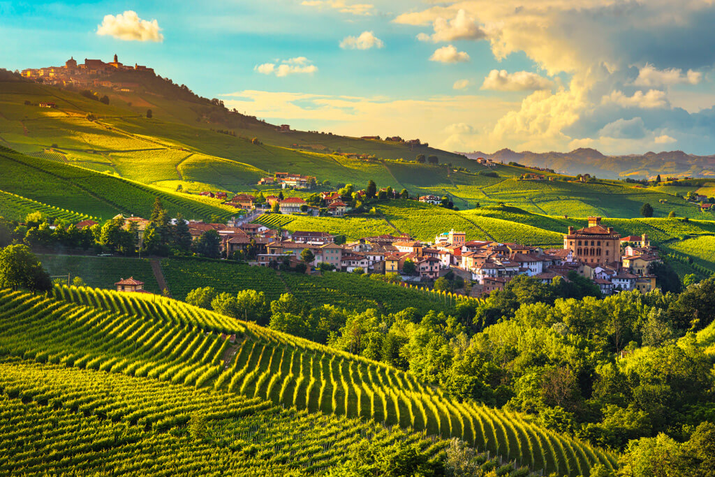 Landscape shot of the low built Italian village of Barolo amongst rolling green landscape. Copyright:DepositPhotos