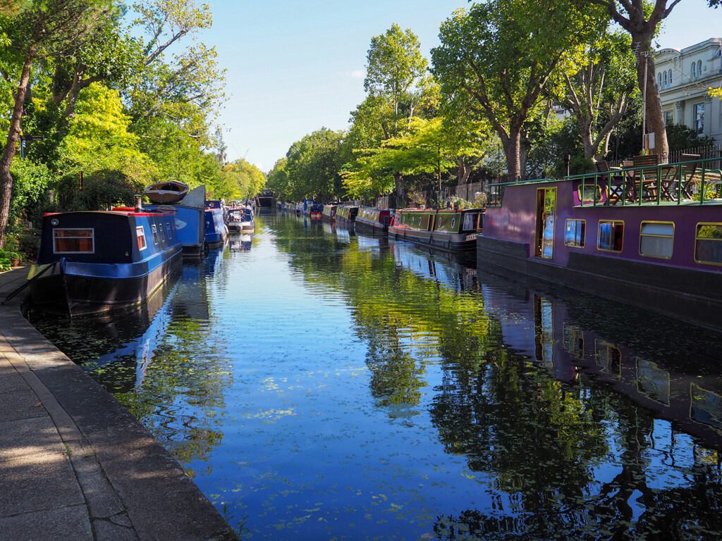 Peaceful canal with houseboats on either side. Copyright@2023mapandfamily.com 