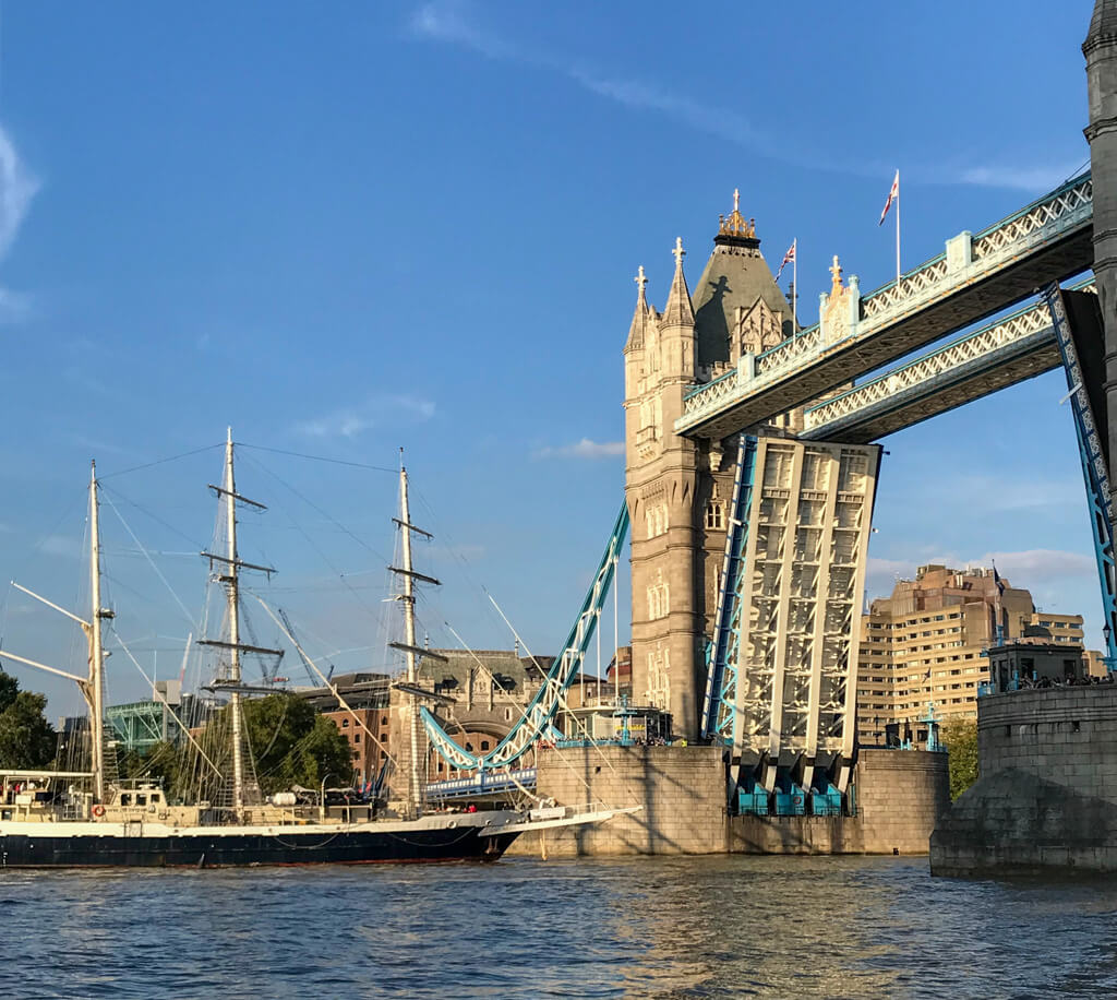 Tower Bridge opening to allow a traditional tall ship to pass along the Thames. Copyright@2023mapandfamily.com 