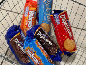 Best British snacks, a selection of biscuit packets in a supermarket basket, Copyright@2023mapandfamily.com