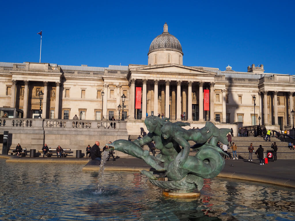 Exterior of National Gallery against blue sky with fountain in foreground. Copyright@2023 mapandfamily.com