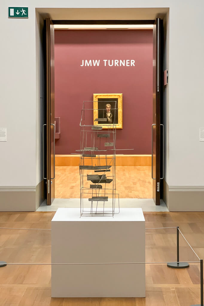 Interior of Tate Britain showing modern sculpture in front of Turner portrait. Copyright@2023 mapandfamily.com