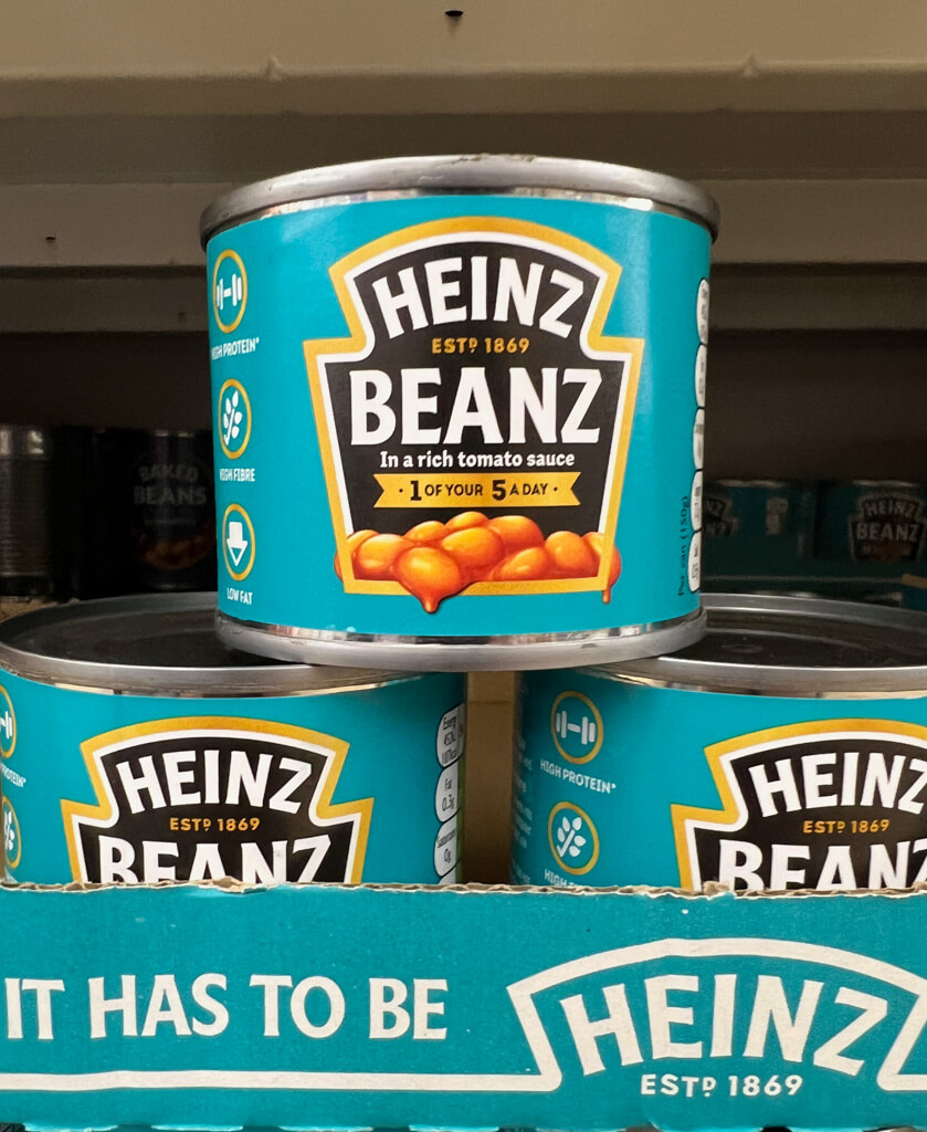 Best British snack: Heinz baked beans stacked in individual tins. Copyright @2023 mapandfamily.com 