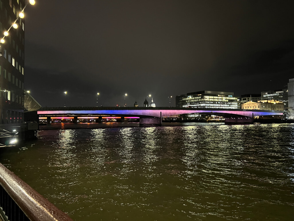 Blue and pink washes of colour on low-built London Bridge at night. Copyright@2023 mapanfamily.com 