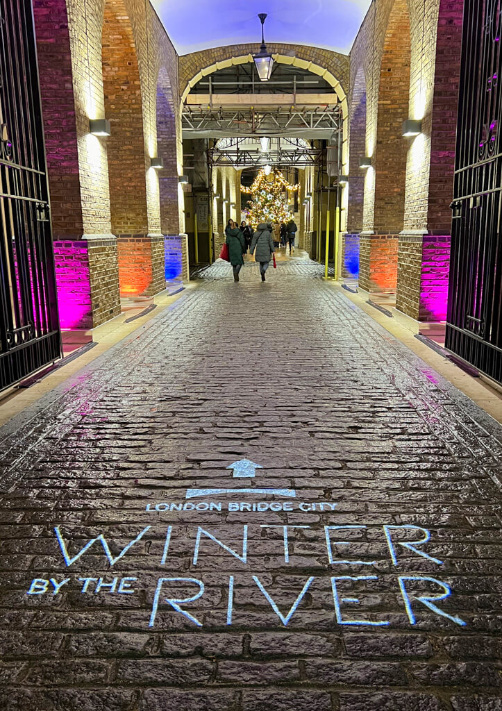 Cobbled entrance to Hay's Galleria with Christmas tree in the distance. Copyright@2023 mapanfamily.com 