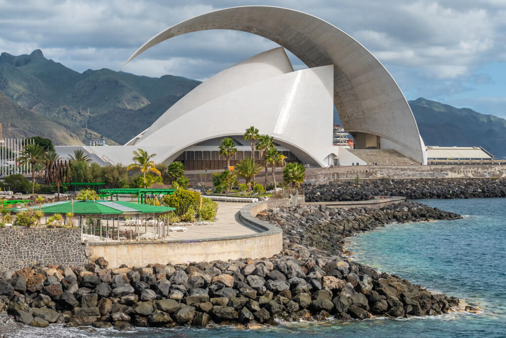 The modern brilliant white auditorium shaped like a sail on coast of Tenerife. 