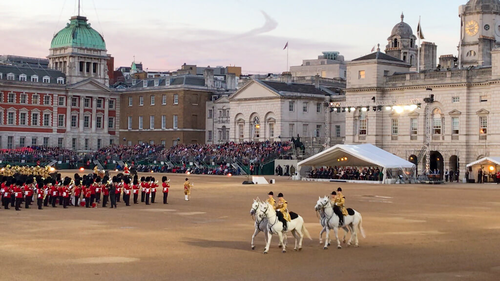 Guards in red tunics and ceremonial guards on white horses parade at Horseguards on a June evening. Copyright@2024 Nancy Roberts