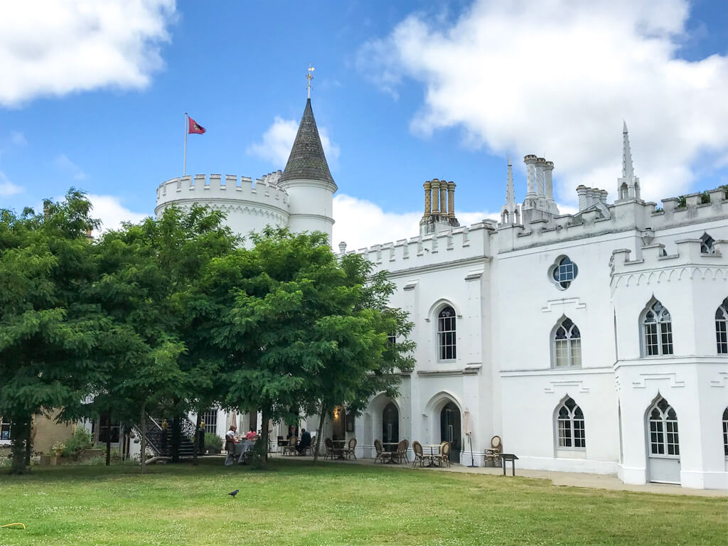  A fairytale castle style historic white stucco mansion with blue skies and fluffy white clouds above. Copyright@2024 Nancy Roberts